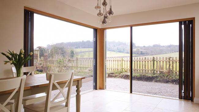 Two joining Centor 205 Integrated Folding Doors in a country cottage
