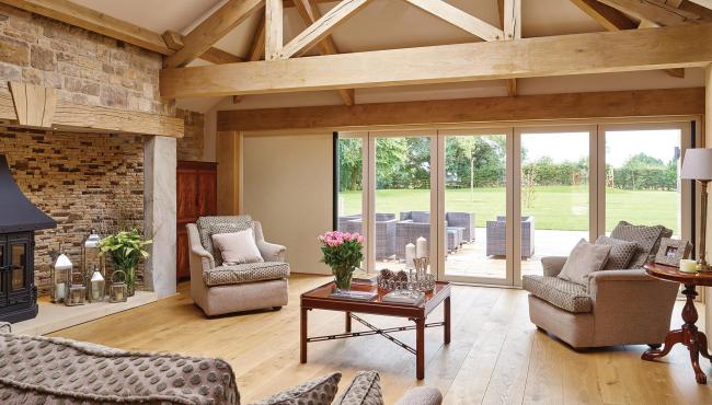 Centor blinds for bifold doors are concealed within the door frame as a space saving solution