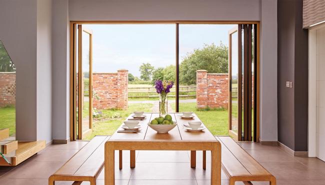 Centor 205 Integrated Folding Door with built-in insect screen for a barn conversion