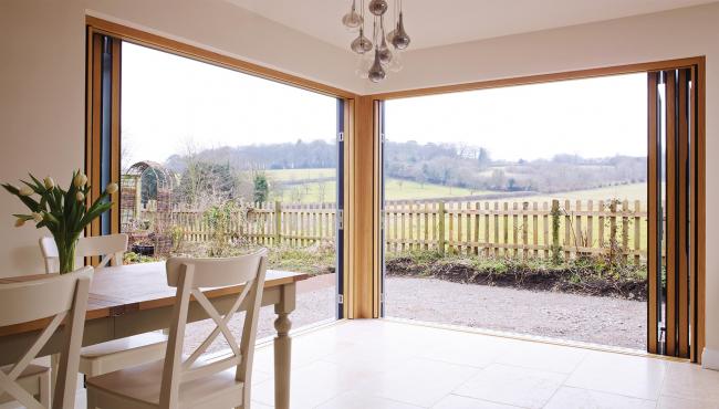 Two joining 205 Integrated Folding Doors overlooking farmland
