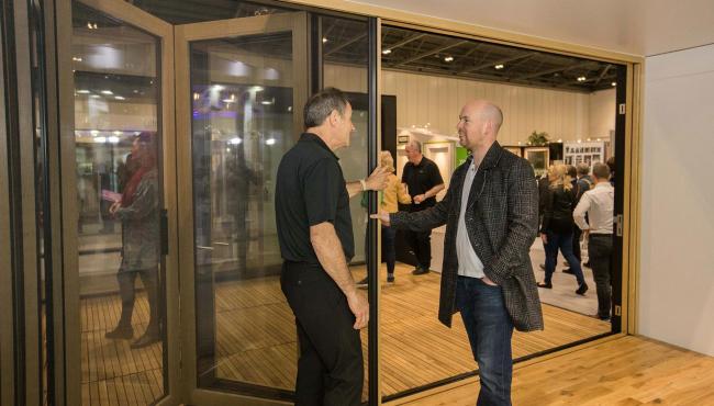 Centor staff demonstrating the built in insect screen included in Integrated Doors