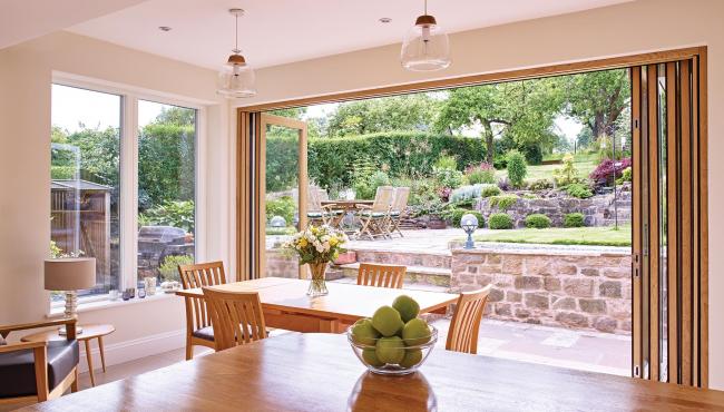 Oak bifold doors from Centor allow to connect with the outside